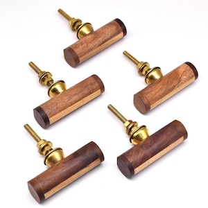 May include: Five wooden cabinet knobs with brass hardware. The knobs are made of two different types of wood, creating a striped pattern.