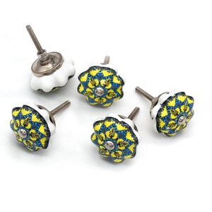 Hand-painted ceramic furniture knob with scalloped edge, yellow and blue mandala pattern, metal screw center for drawer pull.