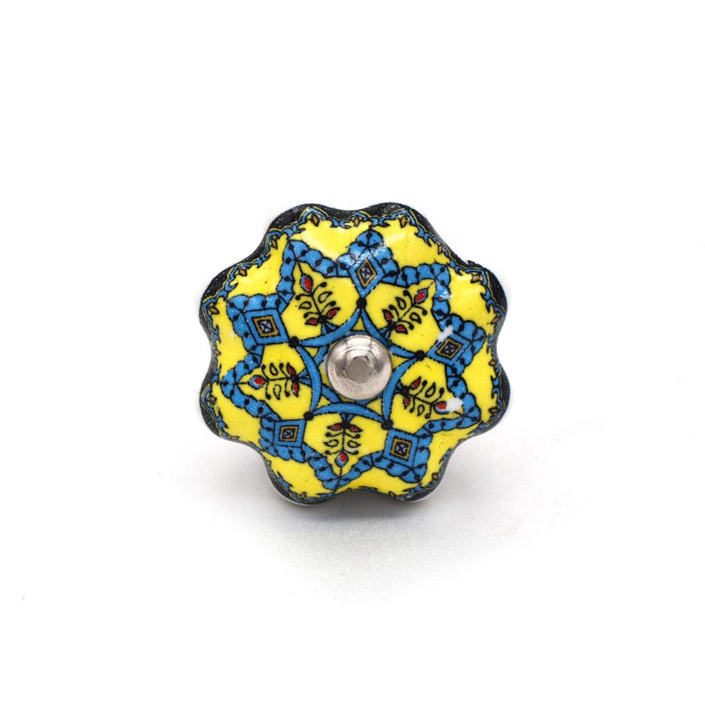 Hand-painted ceramic furniture knob with scalloped edge, yellow and blue mandala pattern, metal screw center for drawer pull.