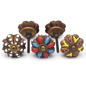 Hand-painted ceramic pumpkin knobs with colorful floral mandala designs in blue, white, red and yellow for cabinets.