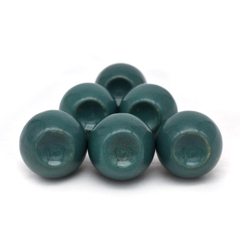 Pair of green ceramic knobs with brass hardware, perfect as drawer knobs or cabinet pulls.