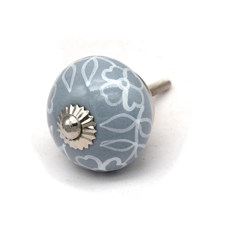 Grey ceramic knob with white hand-painted floral pattern; vintage shabby chic cabinet drawer pull with silver mounting stud.