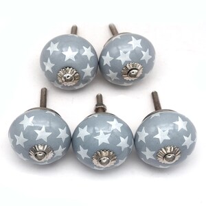 gray ceramic cabinet knobs, hand-painted in white with stripes, dots, flowers, stars, and hearts.