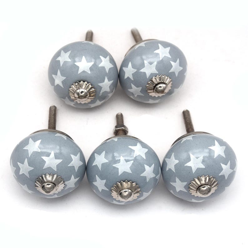 gray ceramic cabinet knobs, hand-painted in white with stripes, dots, flowers, stars, and hearts.