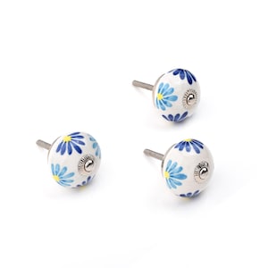 Assorted hand-painted ceramic knobs with blue and turquoise floral motifs for kitchen décor and knob cupboards.