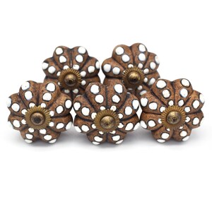 Hand-painted ceramic pumpkin knobs with colorful floral mandala designs in blue, white, red and yellow for cabinets.