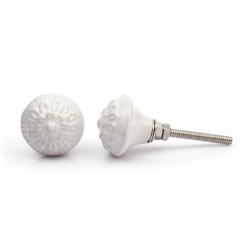 May include: A collection of twelve decorative cabinet knobs in various colours and patterns. Each knob features a round or oval shape with a metal bolt extending from the back. The designs include floral, geometric, and solid textures in shades of green, blue, orange, purple, white, and grey.