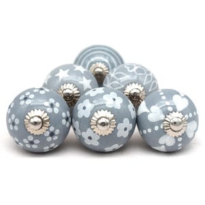 gray ceramic cabinet knobs, hand-painted in white with stripes, dots, flowers, stars, and hearts.
