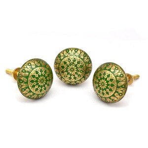 Brass cabinet knobs in vintage style with green and gold etched mandala pattern; decorative drawer pulls for furniture hardware.