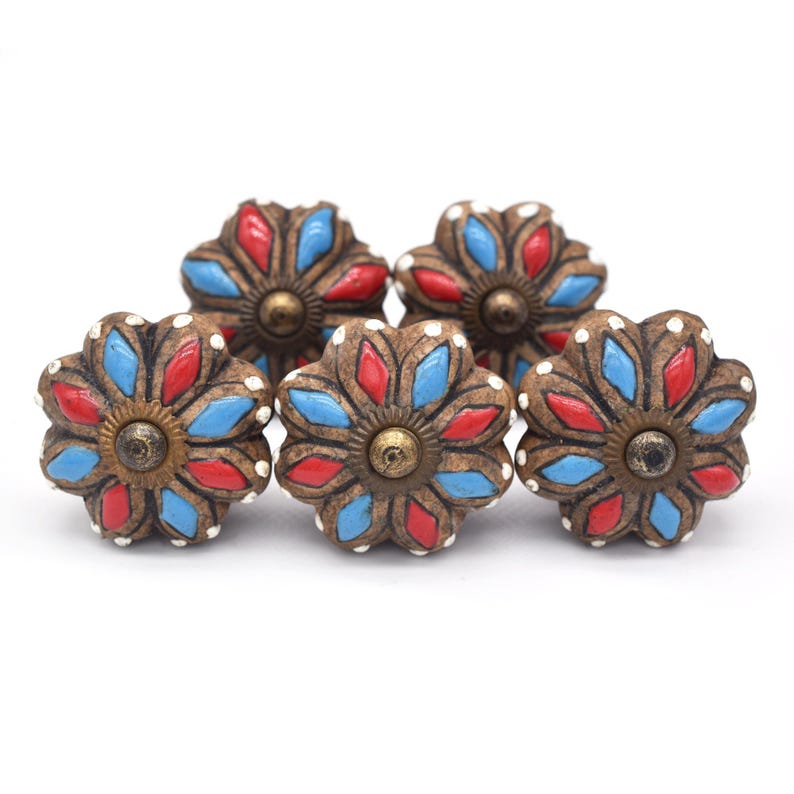 Hand-painted ceramic pumpkin knobs with colorful floral mandala designs in blue, white, red and yellow for cabinets.