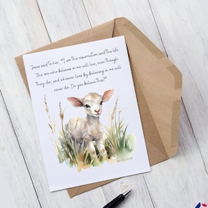 May include: A greeting card featuring a watercolor illustration of a lamb in tall grass. The card includes the text "Jesus said to her, 'I am the resurrection and the life.'" and a Bible verse. The card is inside a brown envelope.