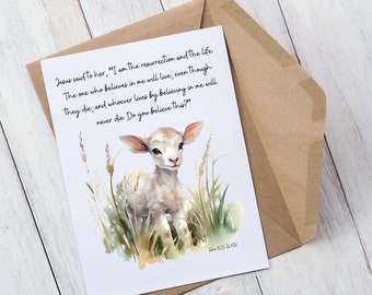 May include: A greeting card with a watercolour illustration of a lamb in long grass. The card includes the text "Jesus said to her, 'I am the resurrection and the life.'" and a Bible verse. The card is inside a brown envelope.