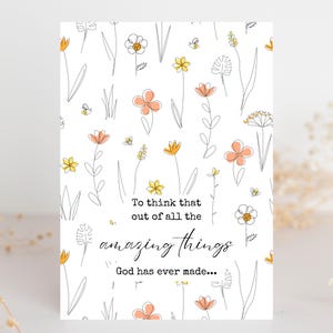 May include: A white greeting card with a floral design featuring orange and yellow flowers, green stems, and small bees. The card has the text: "To think that out of all the amazing things God has ever made..."