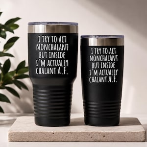 May include: Two black stainless steel tumblers with silver rims and lids. Each tumbler features the white text: I TRY TO ACT NONCHALANT BUT INSIDE I'M ACTUALLY CHALANT A.F. The larger tumbler has a ribbed base, while the smaller one is smooth.