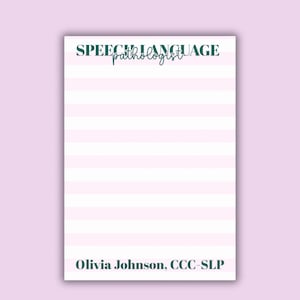 May include: A notepad with pink and white horizontal stripes. The words "SPEECH LANGUAGE pathologist" are printed at the top in dark green. The name "Olivia Johnson, CCC-SLP" is printed at the bottom in black.