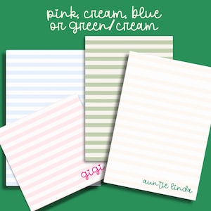 May include: Four sheets of lined paper with different colored stripes. The paper is pink and white, green and white, blue and white, and cream and white. The paper is labeled "gigi" and "auntie linda".