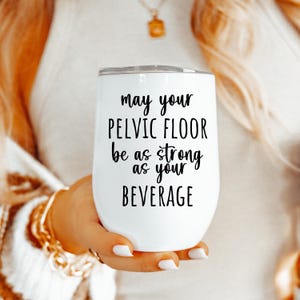 May include: White stainless steel wine tumbler with black text that reads "May your pelvic floor be as strong as your beverage".