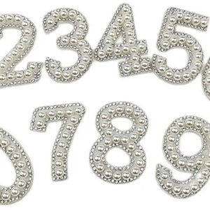May include: A set of silver number embellishments, each number from 0 to 9 is decorated with small, shiny beads. Ideal for crafts, scrapbooking, or adding a decorative touch to various projects.