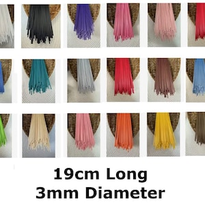 May include: A selection of colourful tassels in shades like white, black, purple, pink, and red. Each tassel is 19cm long with a 3mm diameter. The tassels are presented against a woven backdrop.