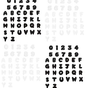 May include: A collection of iron-on patches featuring the numbers 0 through 9 and the uppercase alphabet letters A through Z. The set includes two distinct colour variations, with one set in solid black and the other in a light, off-white shade.
