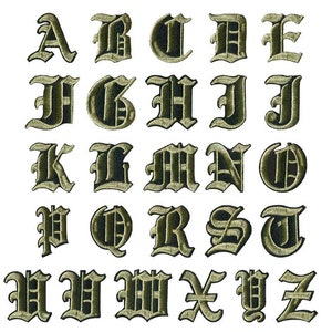 May include: A full set of embroidered iron-on patches displaying the alphabet in a gothic font. Each letter is dark green with a lighter green outline. Ideal for personalising clothing or accessories. The patches are arranged on a white background.