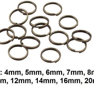 May include: A selection of bronze-toned split key rings in various sizes. The image shows rings from 4mm to 20mm in diameter. The rings are open, ready for use. The key rings are displayed against a white backdrop.