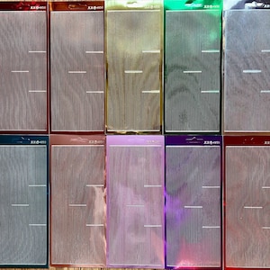May include: Ten sheets of metallic stickers in a range of colours, such as red, gold, green, and purple. Each sheet has vertical lines with horizontal breaks. The text "XX@4950" is printed at the top of each sheet.