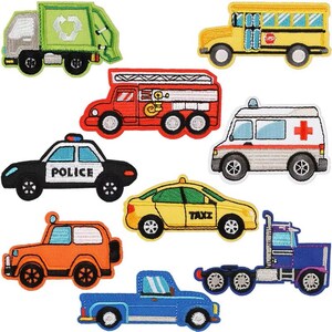May include: A selection of embroidered vehicle patches. Includes a green refuse truck, yellow school bus, red fire engine, white ambulance, black police car, yellow taxi, orange jeep, blue pickup truck, and a blue articulated lorry.