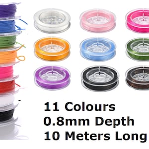 May include: Eleven spools of elastic string in various colours, each on a clear plastic spool. The colours include purple, blue, green, orange, pink, red, white, light blue, dark green, black, and brown. Text on the image reads: 11 Colours, 0.8mm Depth, 10 Metres Long.