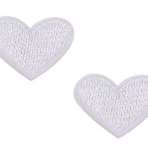 May include: Two white heart-shaped embroidered patches. Each patch features a white border and a textured, stitched interior. The hearts are set against a plain white background, creating a clean and simple aesthetic.