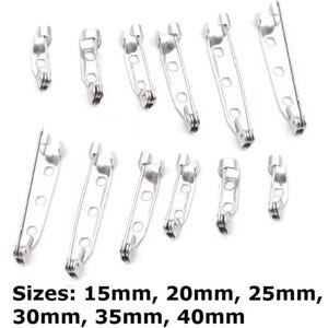 May include: An assortment of silver brooch pin backs in different sizes. The image shows several pin backs, with sizes from 15mm to 40mm, as stated in the text. These are used in crafting and jewellery making.