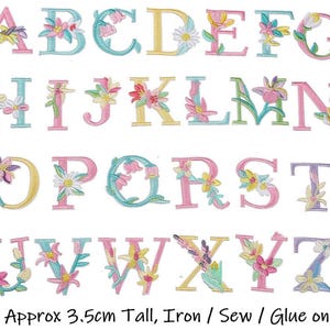 May include: Embroidered alphabet letters, each approximately 3.5cm tall, in pastel shades. Each letter is adorned with floral designs in pink, yellow, blue, and green. The text at the bottom reads: Approx 3.5cm Tall, Iron / Sew / Glue on.