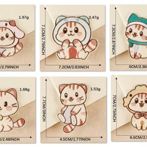 May include: A collection of six cat-themed stickers. Each sticker features a cartoon cat in different outfits. Measurements are provided in centimetres. The stickers are set against a light brown background.