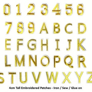 May include: A selection of gold embroidered patches displaying numbers 0-9 and the alphabet A-Z. Each patch is outlined in white. The text at the bottom reads "4cm Tall Embroidered Patches - Iron / Sew / Glue on."
