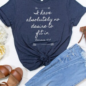May include: A navy blue t-shirt with the text "I have absolutely no desire to fit in. Romans 12:2" printed in white.