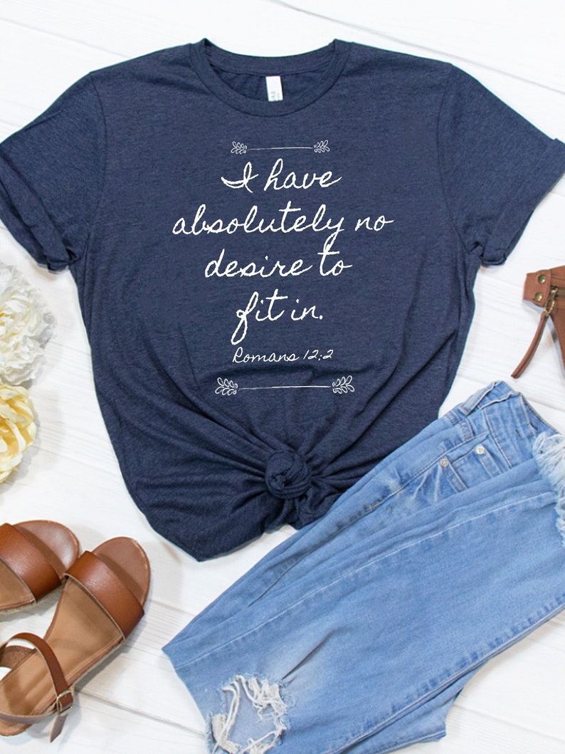May include: A navy blue t-shirt with the text "I have absolutely no desire to fit in. Romans 12:2" printed in white.