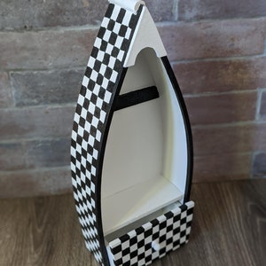 May include: A white and black checkered wooden boat shelf with a small drawer. The shelf has two levels and the drawer has a small knob.