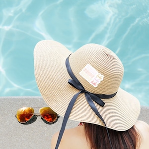 Bride Tribe sticker on Womans Hat in pool