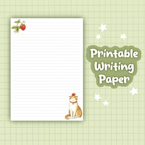 May include: Printable writing paper with a lined design. The top of the page features a strawberry illustration. A cartoon cat wearing a strawberry hat is at the bottom. The words "Printable Writing Paper" are in a green bubble.
