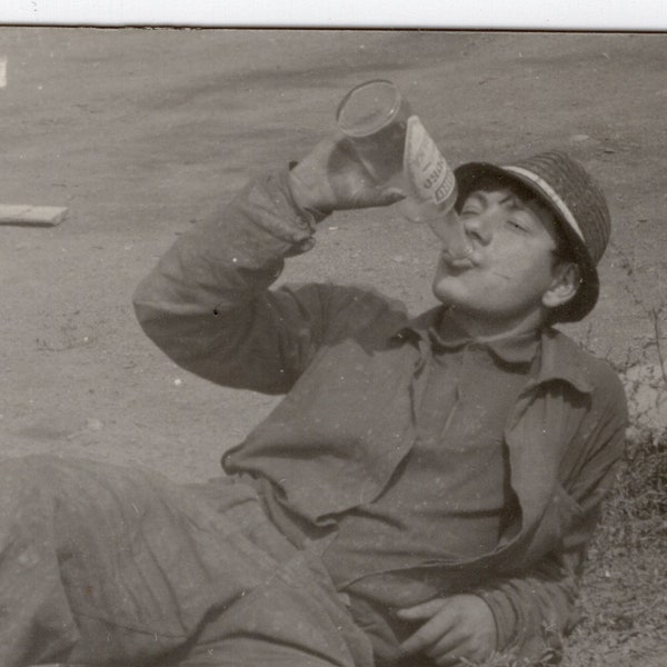 Man emptying a bottle, Found vintage snapshot