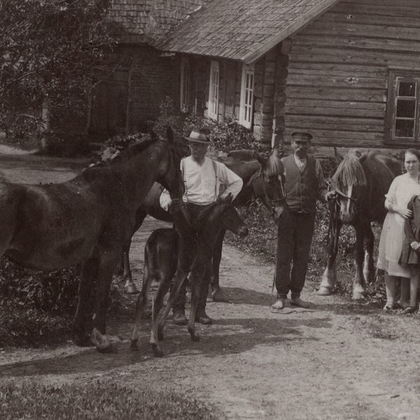 Family gathering with horses, 1930s. Vintage photo