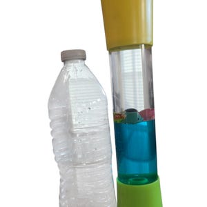 May include: A clear plastic water bottle and a tall, colorful sensory toy. The toy has a yellow top and a green base, with a clear tube filled with blue liquid and small floating objects.