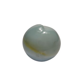 May include: A single, translucent marble with a pale blue and yellow swirl design. The glass marble has a glossy finish and a slightly irregular shape, with a small raised area on top.