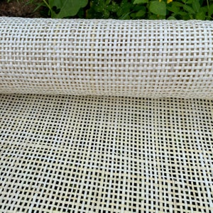 May include: A roll of white cane webbing, a woven material used for upholstery and furniture making.