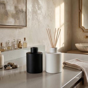 May include: A white ceramic mug with a black handle and the text "But First, Coffee" in a bold, black font. The mug is filled with a dark liquid, likely coffee, and sits on a light-colored surface.