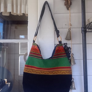 Aguayo zippered handbag, top has Tribal Aguayo and bottom half black aguayo, wooden rings on straps