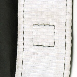 May include: White watch strap with black stitching and multiple holes for adjusting the size. The strap is made of a woven fabric.