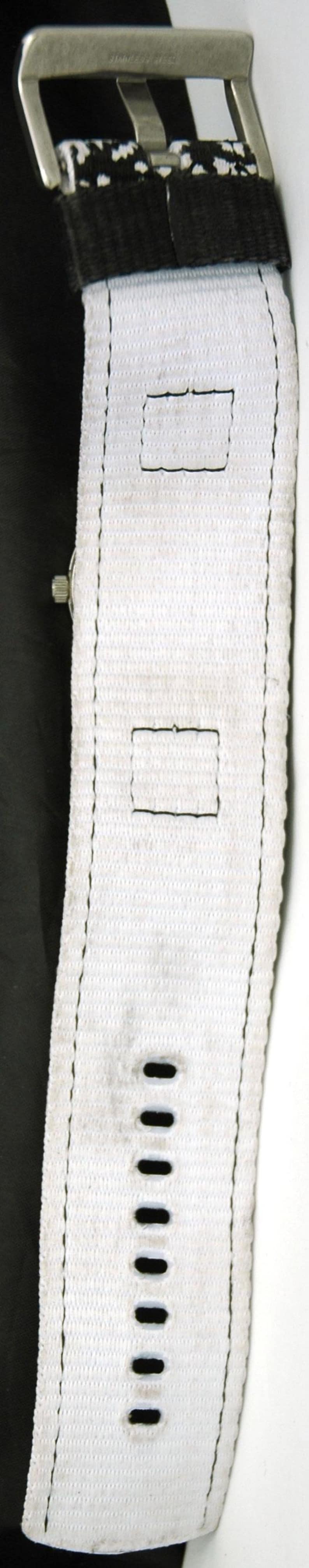 May include: White watch strap with black stitching and multiple holes for adjusting the size. The strap is made of a woven fabric.