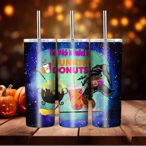 May include: Three stainless steel tumblers with lids and straws. The tumblers feature a galaxy-like background with a witch flying on a broomstick, a cauldron, and a Dunkin' Donuts coffee cup. The text on the tumbler reads "This Witch is Fueled by Dunkin' Donuts".