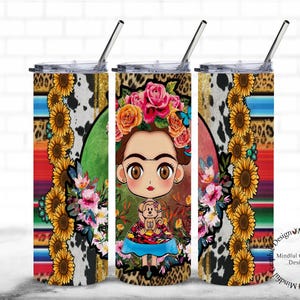 May include: A stainless steel tumbler with a colorful design featuring a cartoon Frida Kahlo with flowers in her hair and a small dog. The background is a colorful pattern of stripes, leopard print, and sunflowers.